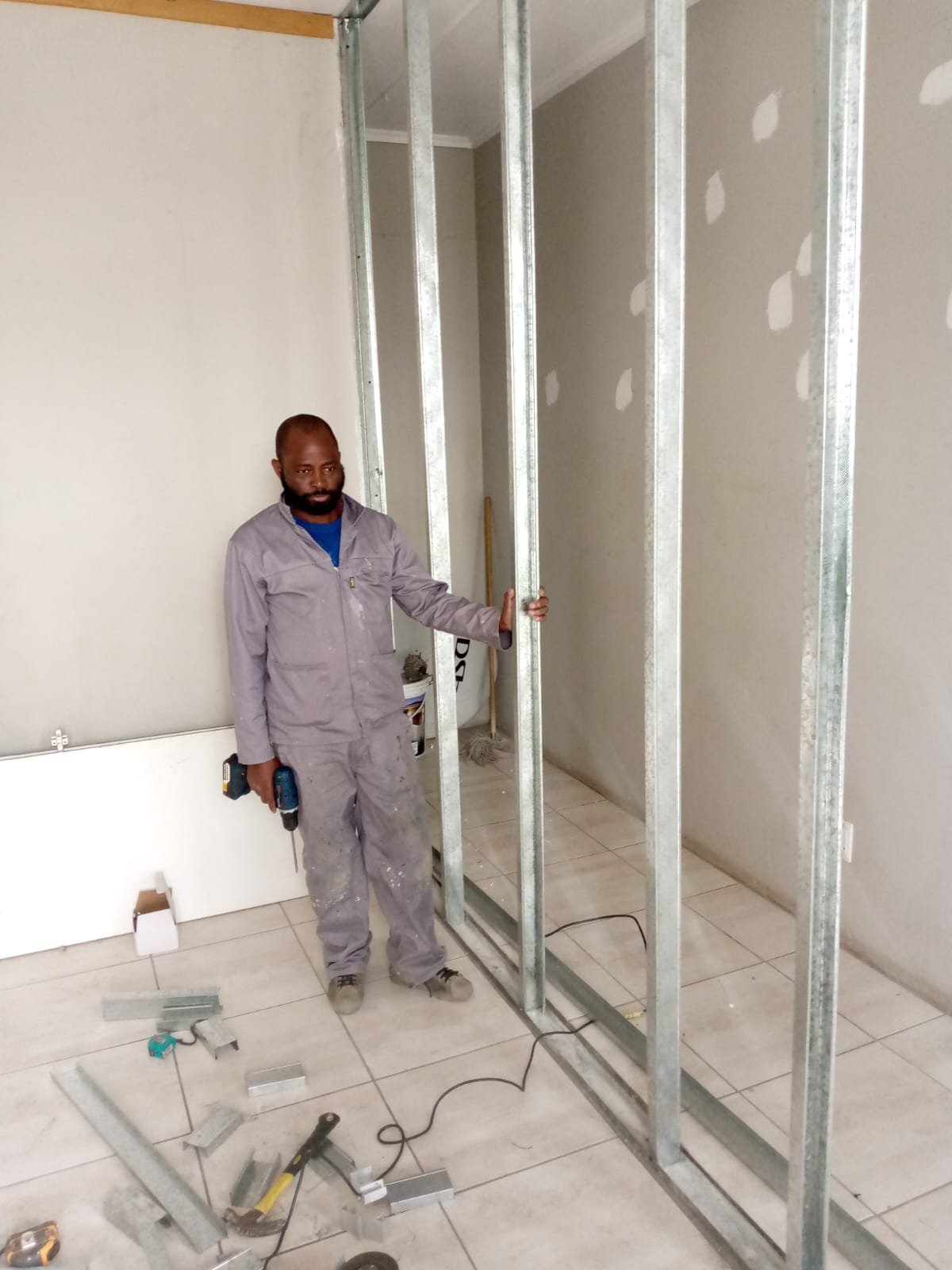 Innocent of Biazo Katalambano on site building a partition wall